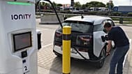 A man charges his BMW electric vehicle at the rest stop Brohltal Ost at the A61 motorway in Niederzissen, Germany, May 11, 2018.