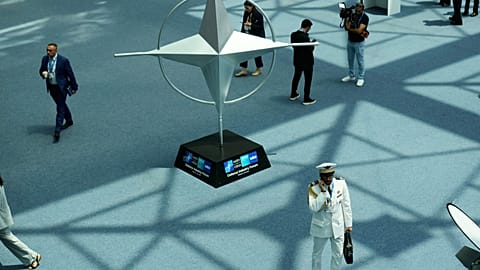 Participants walk near displays during the NATO Defence Industry Forum at the NATO summit in Ankara, Turkey, 7 July 2026