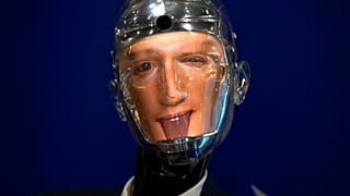 Close of Robert the Robot using the likeness of Meta chief Mark Zuckerberg, winking