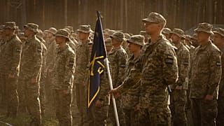 Newly recruited soldiers attend a ceremony as they celebrate the end of their training at a military base close to Kyiv, 25 September, 2023