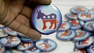 A man holds a Democratic Party pin during a US presidential election event.