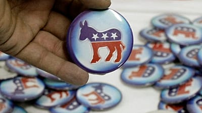 A man holds a Democratic Party pin during a US presidential election event.