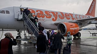 FILE. Passengers board a London-bound EasyJet flight at Amsterdam's Schiphol airport, Netherlands, Nov. 2019
