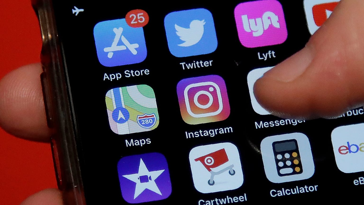 FILE - This July 10, 2019, photo shows an Associated Press reporter holding a phone showing the Instagram app icon in San Francisco. 