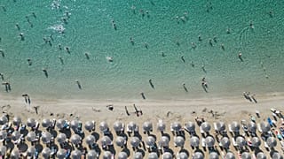People enjoy the sea in Avlaki beach about 42 kilometers (26 miles) east of Athens, Greece, Wednesday, Aug. 19, 2025.