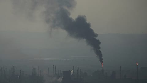 Smoke billows after an Iranian missile struck an oil refinery in Haifa, northern Israel, 16 June 2025