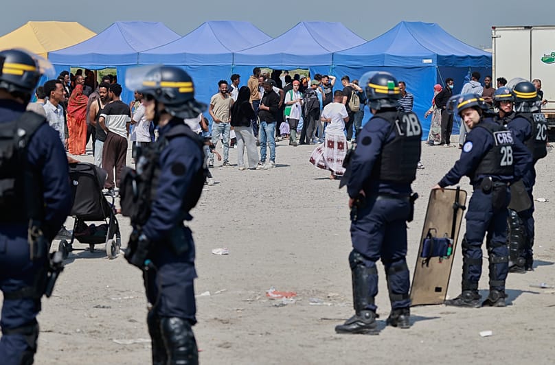 Police conduct a search operation at a makeshift camp of migrants who want to cross the English Channel to Britain near Dunkirk, 27 May, 2026