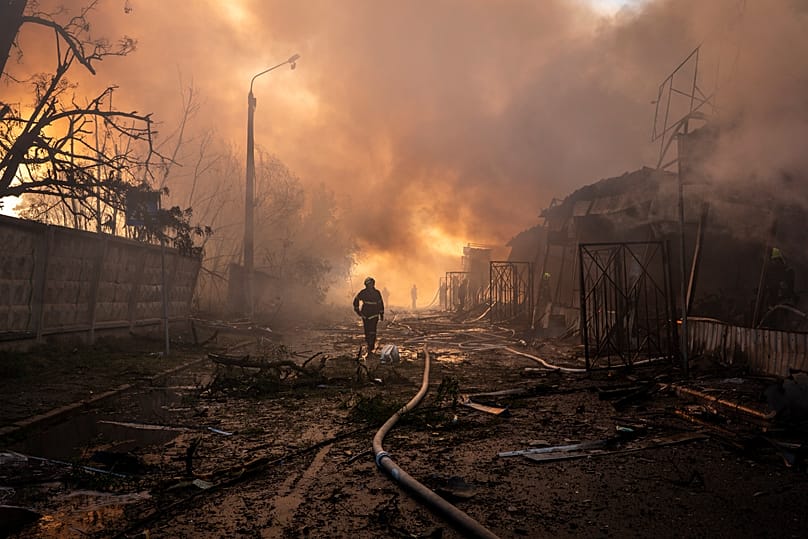 Firefighters try to put out a fire at a city marketplace following a Russian missile and drone attack in Kyiv, 15 June, 2026