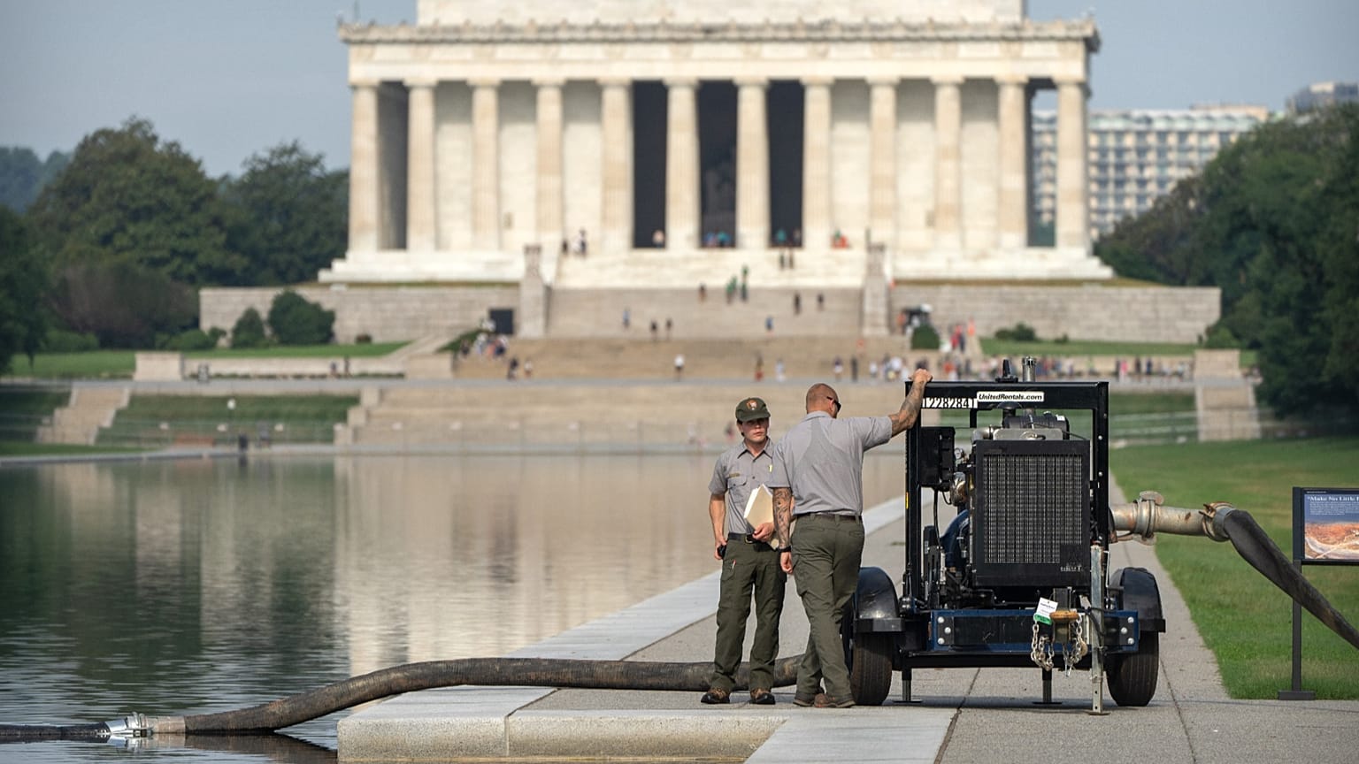 National Park Service workers stand near a pump placed next to the Lincoln Memorial Reflecting Pool, 10 July, 2026