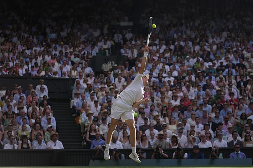 Jannik Sinner of Italy serves to Novak Djokovic of Serbia in their men's singles semifinal match at the Wimbledon Tennis Championships, 10 July, 2026