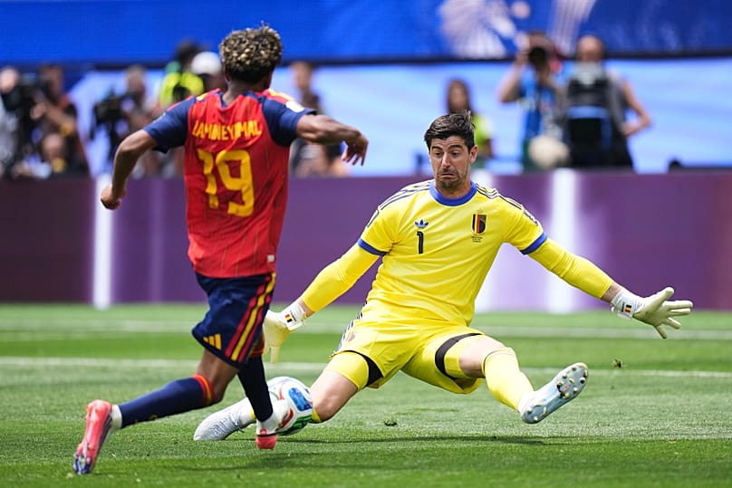 Belgium goalkeeper Thibaut Courtois (1) saves a shot by Spain's Lamine Yamal (19) during the World Cup quarterfinal soccer match between Spain and Belgium in Inglewood, Cal.