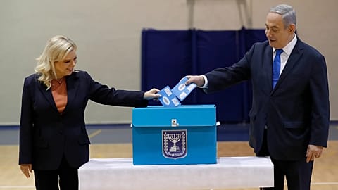 Israeli Prime Minister Benjamin Netanyahu, right, and his wife Sara Netanyahu cast their ballots during the Israeli legislative elections in Jerusalem, Monday, 2 March, 2020