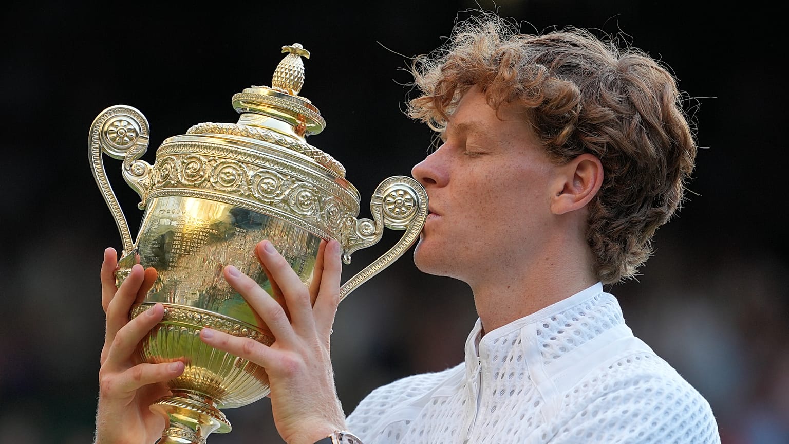 Jannik Sinner of Italy kisses the winners trophy after defeating Alexander Zverev of Germany in the men's singles final at Wimbledon Tennis Championships, July 12, 2026.