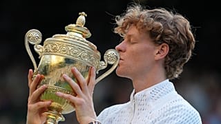 Jannik Sinner of Italy kisses the winners trophy after defeating Alexander Zverev of Germany in the men's singles final at Wimbledon Tennis Championships, July 12, 2026.