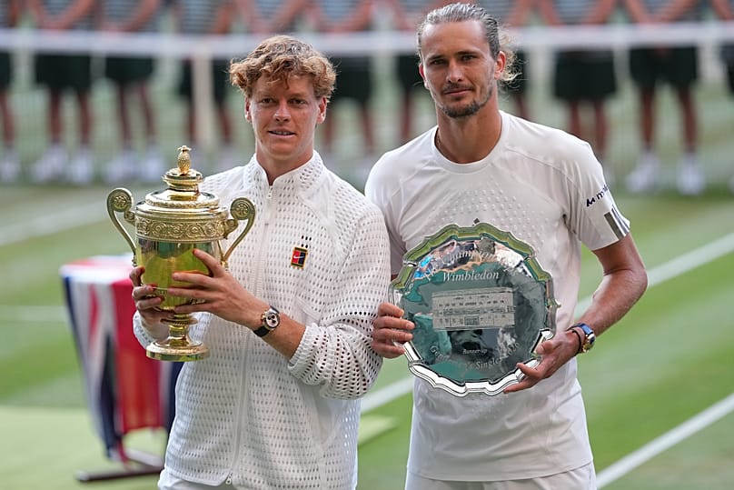 Champion Jannik Sinner of Italy and runner-up Alexander Zverev of Germany pose with their trophies after the men's singles final at Wimbledon Tennis Championships in London.