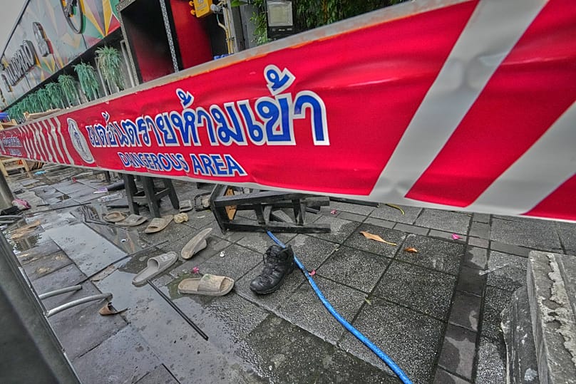 Shoes are seen scattered in front of a pub in Bangkok, 13 July, 2026