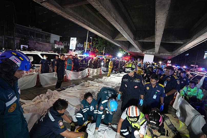 Bodies of victims of a fire are seen laid in a row in Bangkok, 13 July, 2026