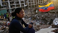 A woman sits amid the rubble of a building waiting to find her two children after the earthquakes in La Guaira, 12 July, 2026