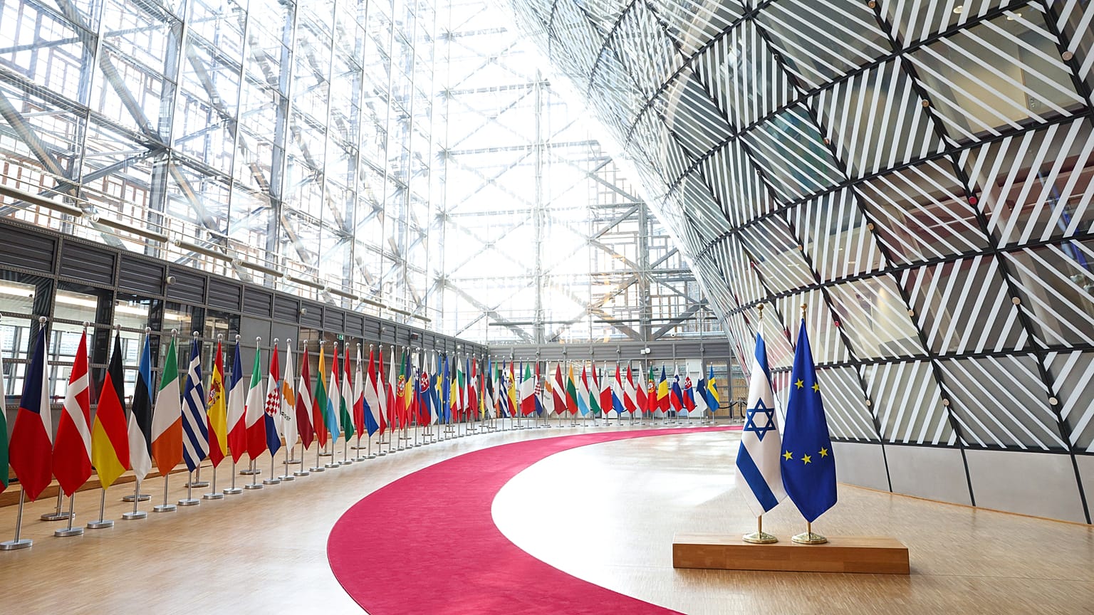 The EU and Israeli flags are seen at the Council of the EU in Brussels