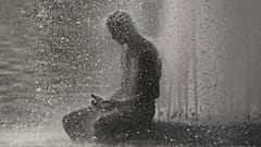 A person cools off at Trocadero fountain near the Eiffel Tower during a heat wave in Paris, 24 June, 2026