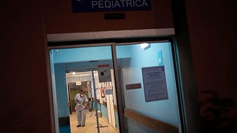 An employee cleans the floor at the entrance to the paediatric emergency department of Garcia de Orta Hospital in Almada, south of Lisbon, Tuesday, 30 November 2021.