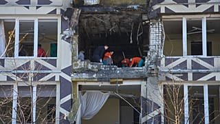 Medical workers remove the debris in a damaged private clinic after a Russian drone hit a hospital room killing a patient in Kyiv, 5 January, 2026