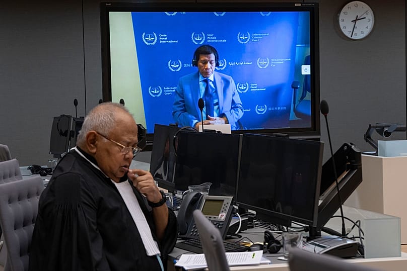 Former Philippine President Rodrigo Duterte is seen on a screen in the courtroom of the ICC with his lawyer Salvador Medialdea, The Hague, Netherlands, Mar. 14, 2025