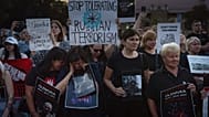 People hold signs outside the Russian embassy in Kyiv, 29 July, 2023