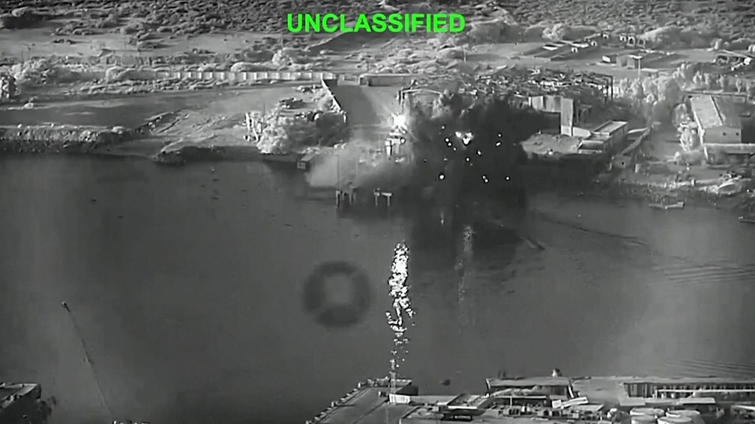 A still image from video shows an explosion at Iran's Bandar Abbas Naval Base after what the US says was a strike by three Corsair unmanned surface vessels on 12 July 2026.