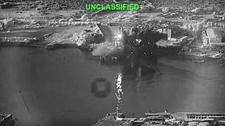 A still image from video shows an explosion at Iran's Bandar Abbas Naval Base after what the US says was a strike by three Corsair unmanned surface vessels on 12 July 2026.