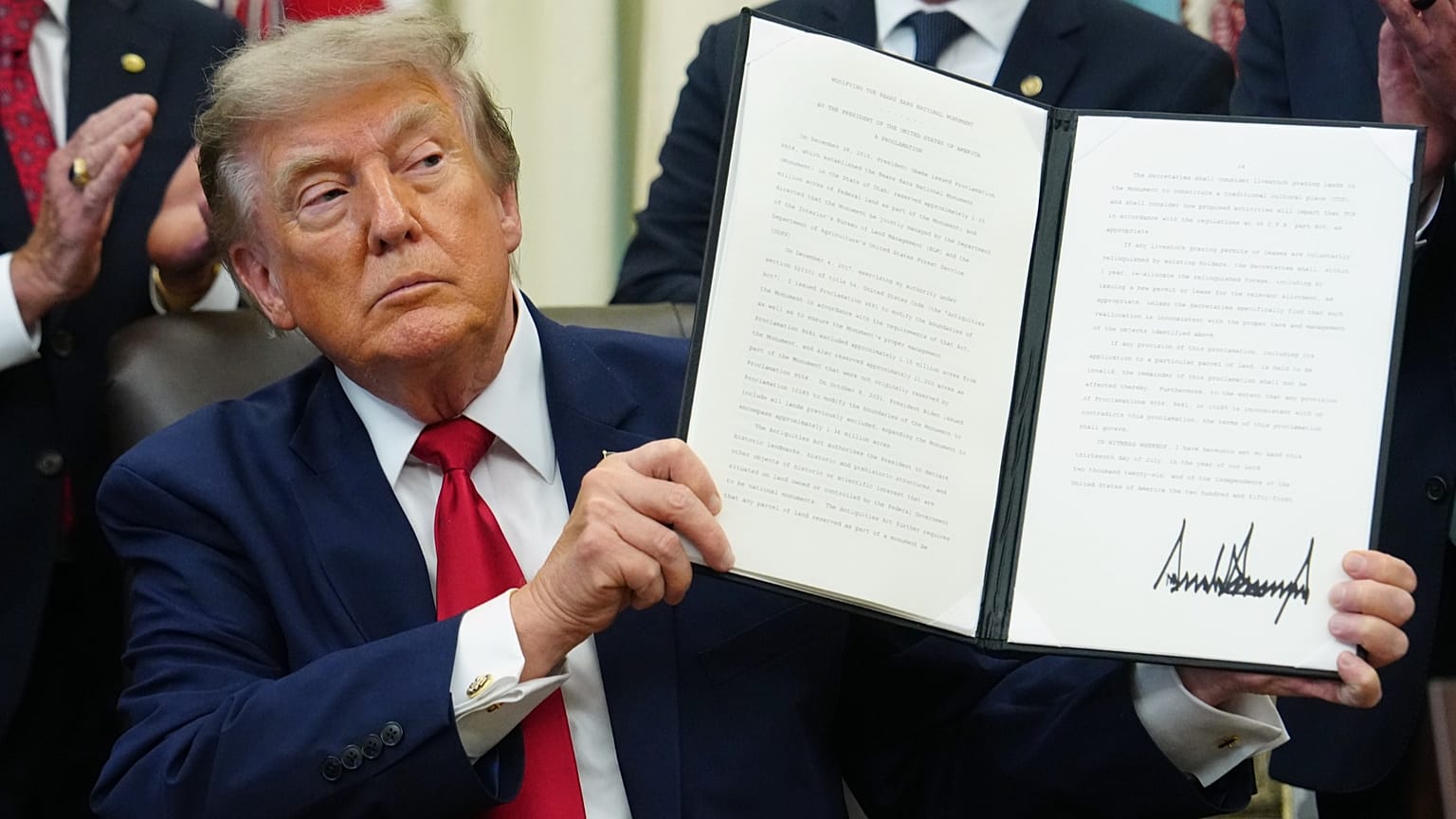 US President Donald Trump holds a signed executive order in the Oval Office of the White House, 13 July, 2026