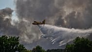 A Canadair water bomber drops water while fighting wildfires in the Fontainebleau forest region, 13 July, 2026