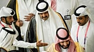 FILE - Former Emir of Qatar Sheikh Hamad bin Khalifa Al Thani, center, arrives before the start of the FIFA World Cup Qatar 2022.