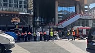 Firefighters and other people outside Oxy Tower building in Brussels, Belgium. 14 July 2026.