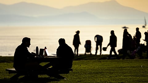 On the shore of Lake Geneva in Lausanne, Switzerland – symbolic image of happy people in the Alpine country