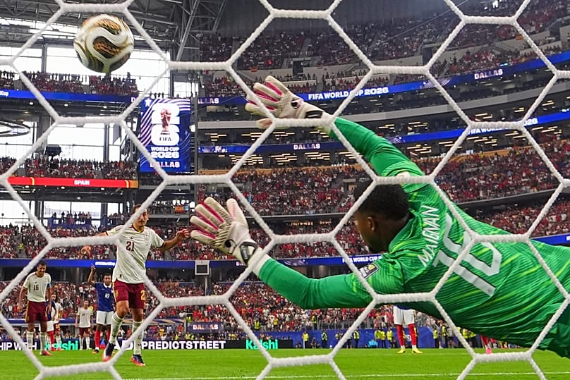 Spain's Mikel Oyarzabal (21) scores their first goal on a penalty kick past France goalkeeper Mike Maignan 