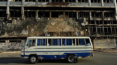 A bus drives past a hotel destroyed during the war in downtown Khartoum, 19 April, 2026