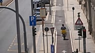 A food delivery rider rides in an empty and sunny road, in Milan, Italy, Wednesday, July 8, 2026. (AP Photo/Luca Bruno)