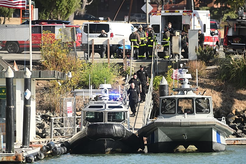 Emergency crews gather at a dock near the site of a pontoon boat fire in San Francisco, 14 July, 2026