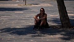 Eine Frau sucht am 27. Mai in Barcelona Schutz unter einem Baum.