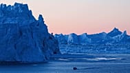 FILE -A boat rides in front of an iceberg at Disko Bay near Ilulissat, Greenland, on 28 Jan. 2026. (AP Photo/Evgeniy Maloletka, File)