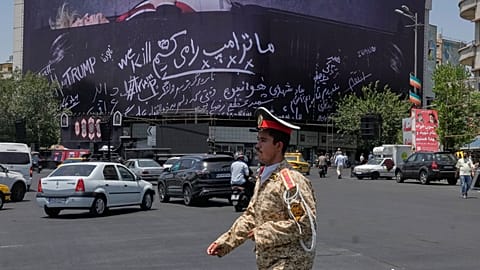 An army cadet walks past a billboard bearing anti-Trump messages, including the phrase "We Kill Trump," at Islamic Revolution Square in downtown Tehran, Iran, 15/07/2026.