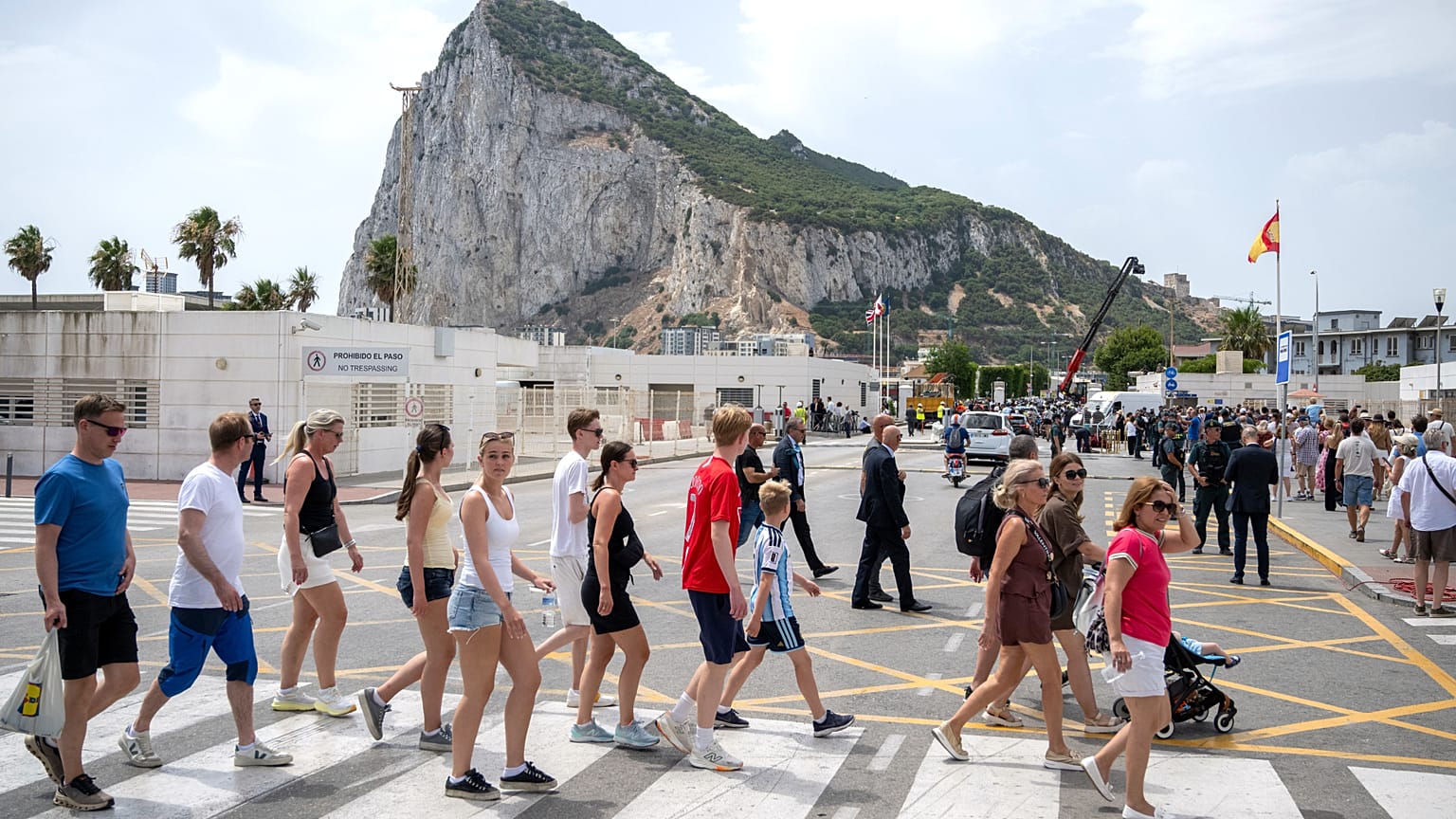 People walk at the Gibraltar-Spain border on the first day of passport-free travel under a new EU-UK treaty, in La Línea de la Concepción, Spain.