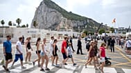 People walk at the Gibraltar-Spain border on the first day of passport-free travel under a new EU-UK treaty, in La Línea de la Concepción, Spain.
