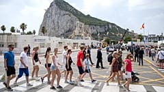 People walk at the Gibraltar-Spain border on the first day of passport-free travel under a new EU-UK treaty, in La Línea de la Concepción, Spain.