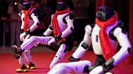 Humanoid robots dance in formation during a Lunar New Year tech temple fair performance in Beijing, Thursday, Feb. 19, 2026.