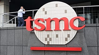 FILE. A person walks into the Taiwan Semiconductor Manufacturing Co., Ltd. (TSMC) headquarters in Hsinchu, Taiwan, Oct. 2021