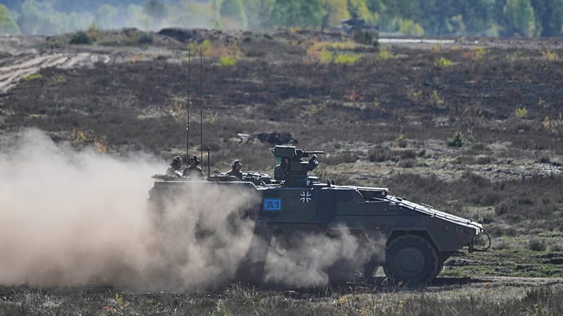 German Chancellor Friedrich Merz drives in an armoured fighting vehicle at the Bundeswehr base in Munster, Germany, Thursday, 30, April 2026.