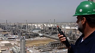 A Kuwaiti oil worker talks on his radio at Mina Abdulah Oil Refinery, 50 Km South of Kuwait City