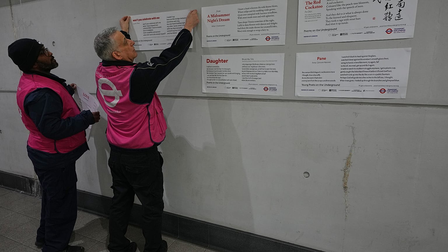 TFL ambassadors display poems at a gathering to celebrate 40 years of 'Poems on the Underground' in London, Friday, 30 Jan., 2026. (AP Photo/Kirsty Wigglesworth)